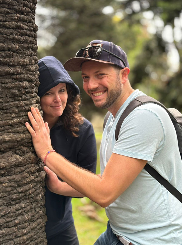 Image of two people with a garden in the background